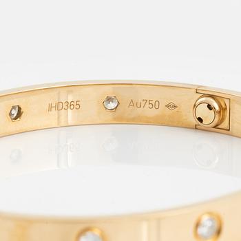 A Cartier "Love" bracelet in 18K gold set with ten round brilliant-cut diamonds.