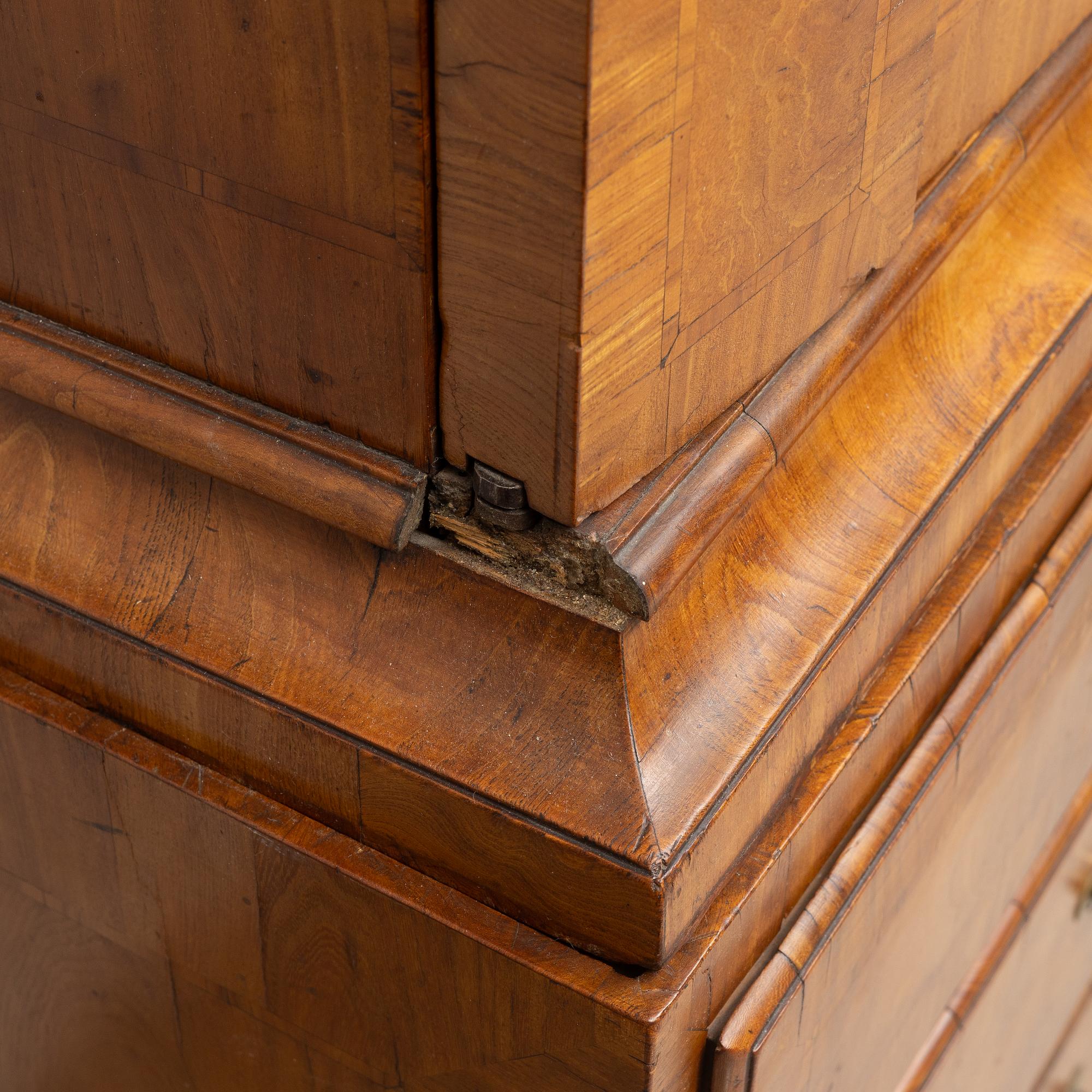 A late Baroque walnut-veneered cabinet in the manner of J. H. Fürloh, mid 18th century.