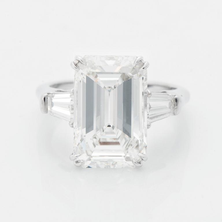 A platinum ring set with an emerald-cut diamond.