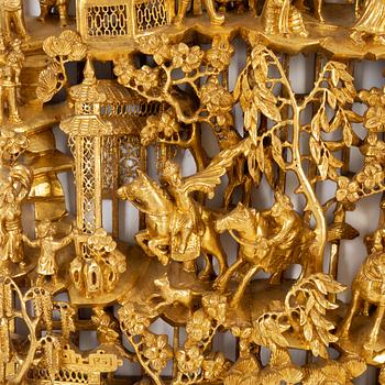 A carved Chinese wooden panel, late Qing dynasty, circa 1900.