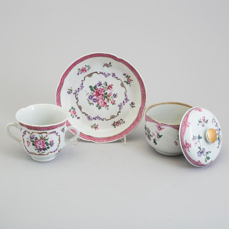 A pair of famille rose cup with stands and a sugar bowl with cover, Qing dynasty, Qianlong (1736-95).