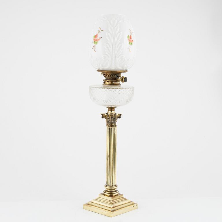 A brass and glass column shaped paraffin lamp, end of the 19th Century.