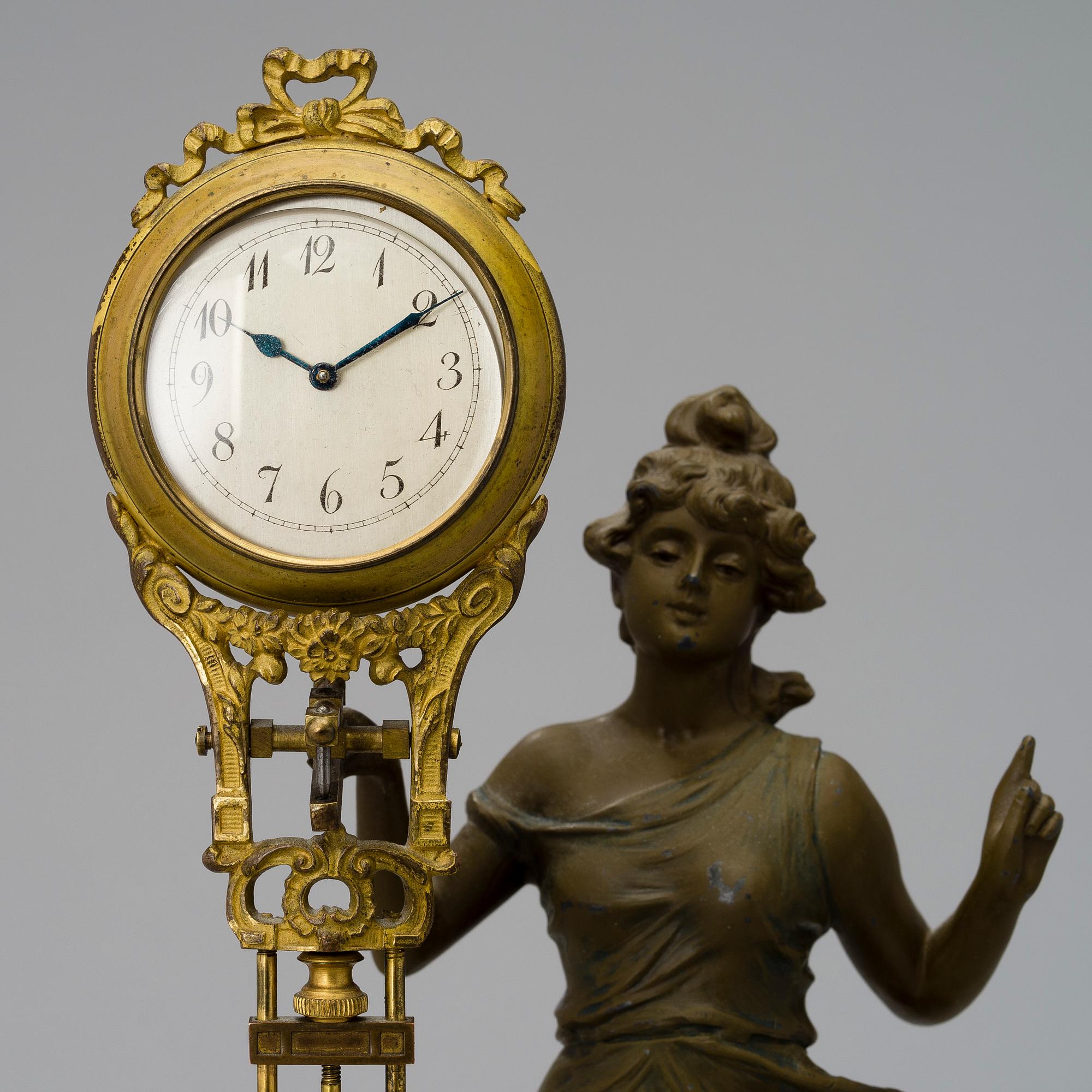 A 1930s Junghans swinger clock with girl sculpture.