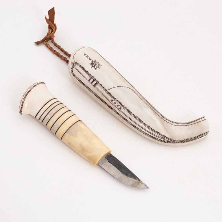 A reindeer horn knife by Tomas Valkeapää, signed and dated 1993.