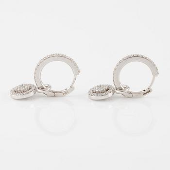 A pair of 18K gold earrings with round brilliant-cut diamonds.
