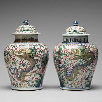 569. Two Transitional Wucai Baluster vases and covers, 17th Century.