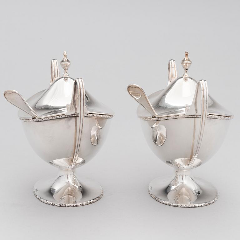 A pair of lidded silver sugar bowls with sprinkle spoons, mark of The Firm Carl Fredrik Carlman, Stockholm 1928-29.