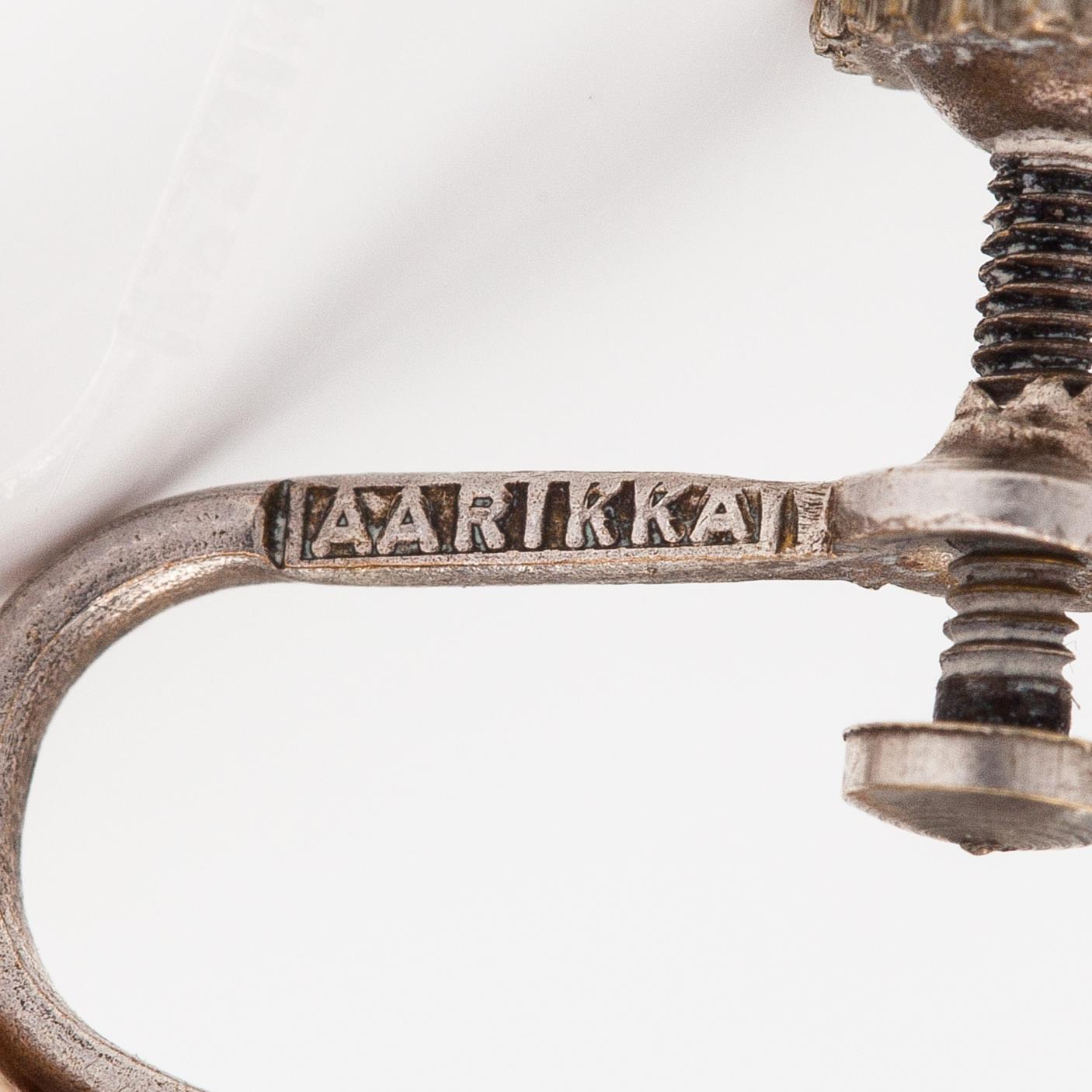 Kaija Aarikka, A necklace, a paid of earrings and a brooch made of silver and wood. Finland.