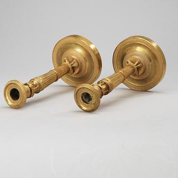 A pair of French Empire early 19th century candlesticks.