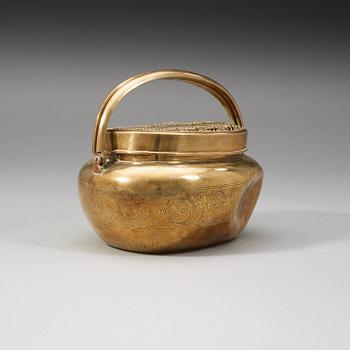 A Chinese engraved paktong hand warmer, Qing dynasty, 19th Century.