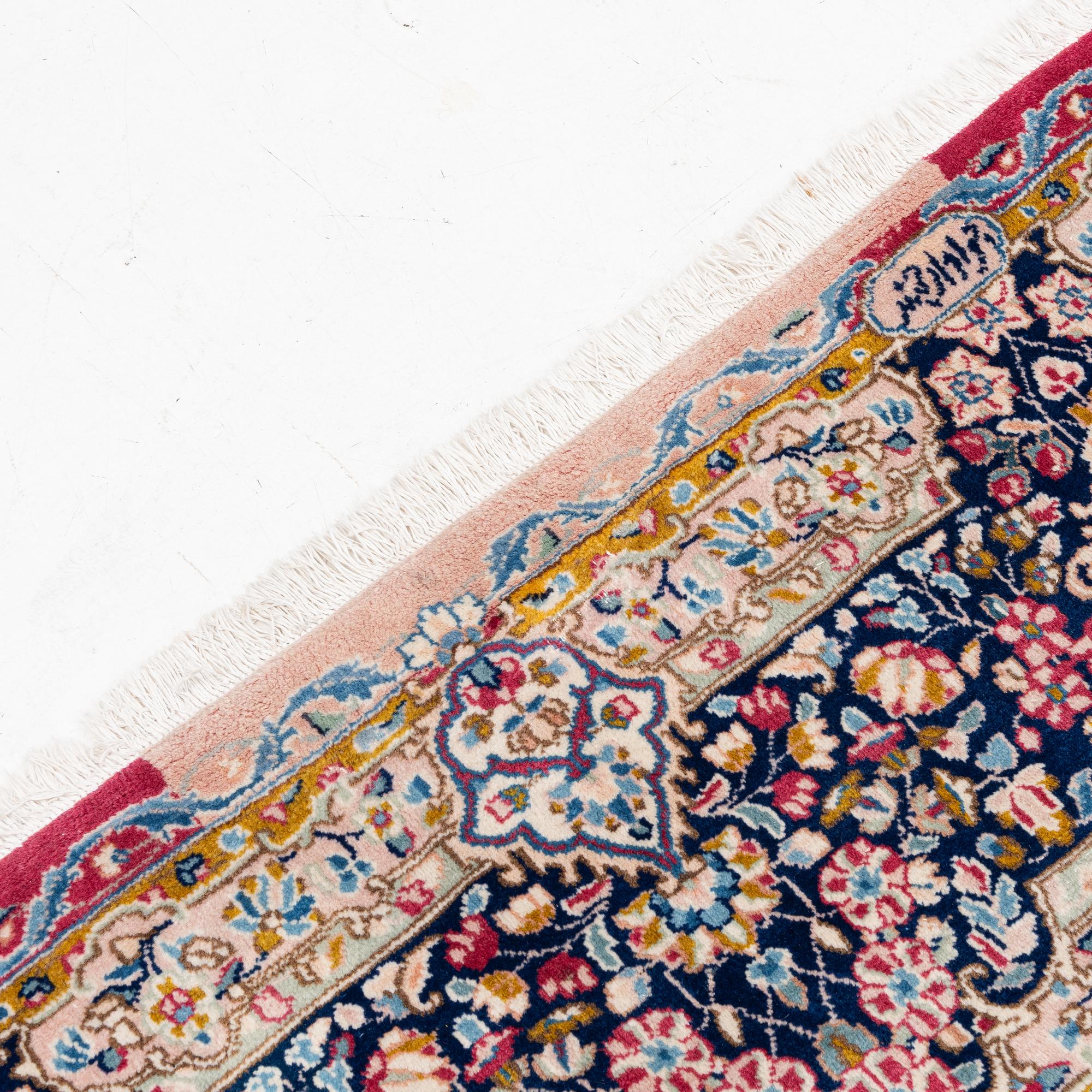 A Kirman carpet, signed, c. 388 x 279 cm.