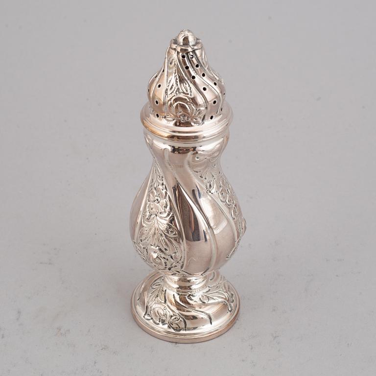 A silver sugar shaker, salt shaker, creamer and napkin holder.