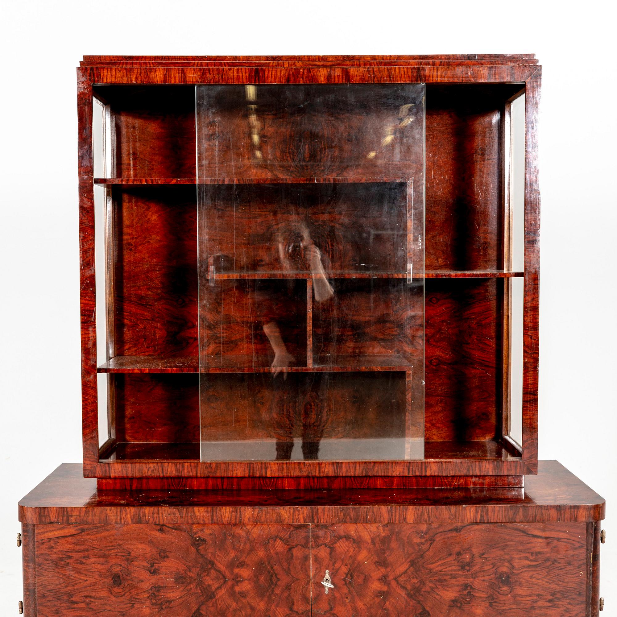 A walnut Art Deco early 1900s display cabinet.