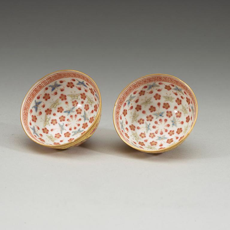 A pair of famille rose yellow ground cups, Qing dynasty, Guangxu six-character mark and of the period  (1875-1908).