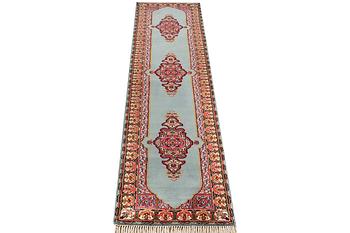 An oriental runner, c. 550 x 74 cm.