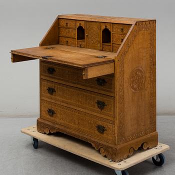 A carved oak secretaire, 19th Century.