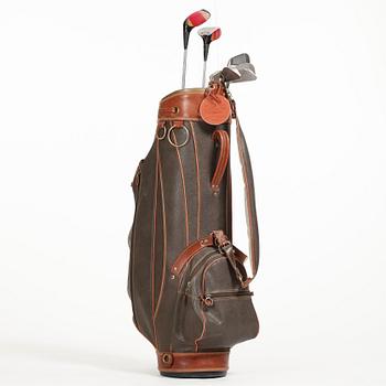 MULBERRY, a green leather golf bag with golf clubs.