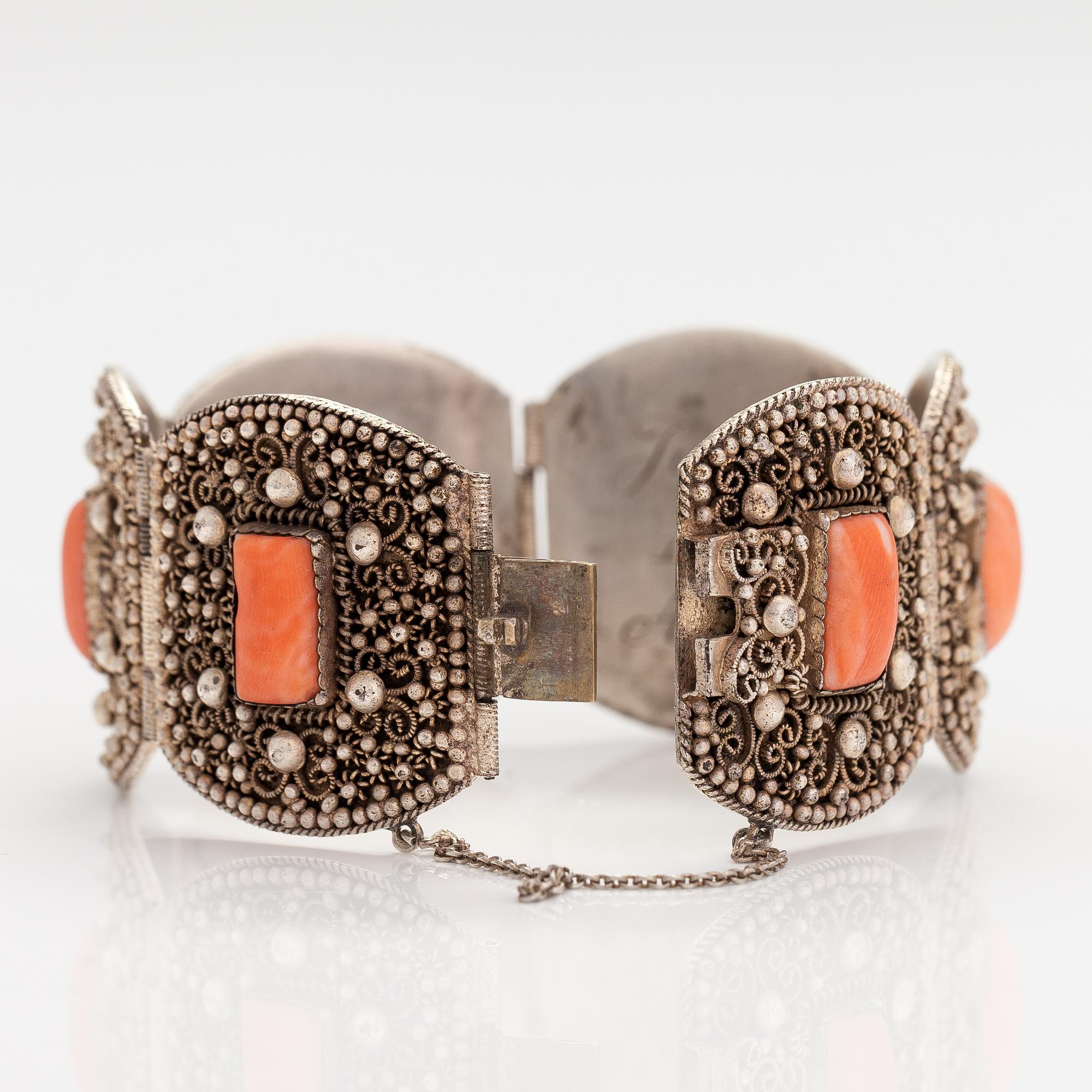 A silver bracelet with corals.