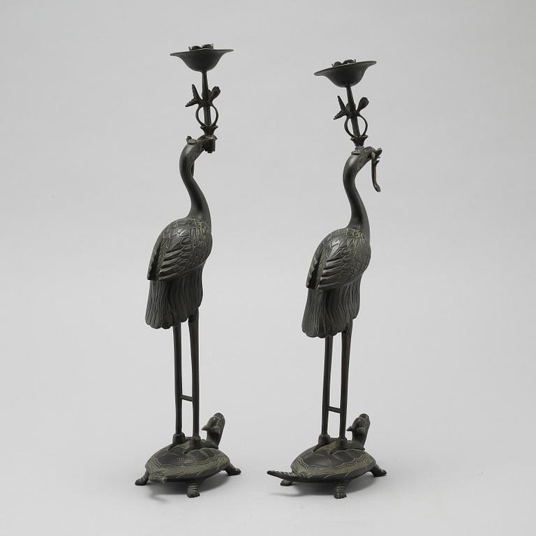 A pair of bronze candlesticks, China, 20th Century.