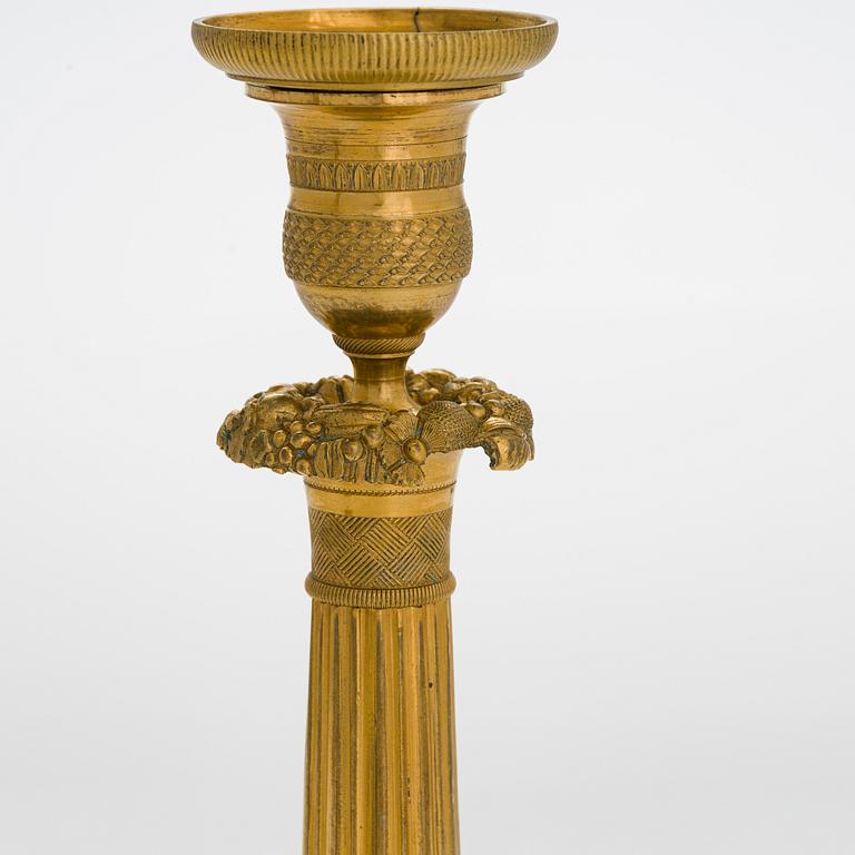 A pair of Empire ormolu brass candlesticks, France early 19th century.