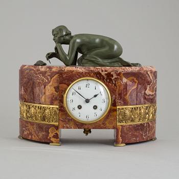 An early 20th century mantle clock with a bronze sculpture signed M. Charny.
