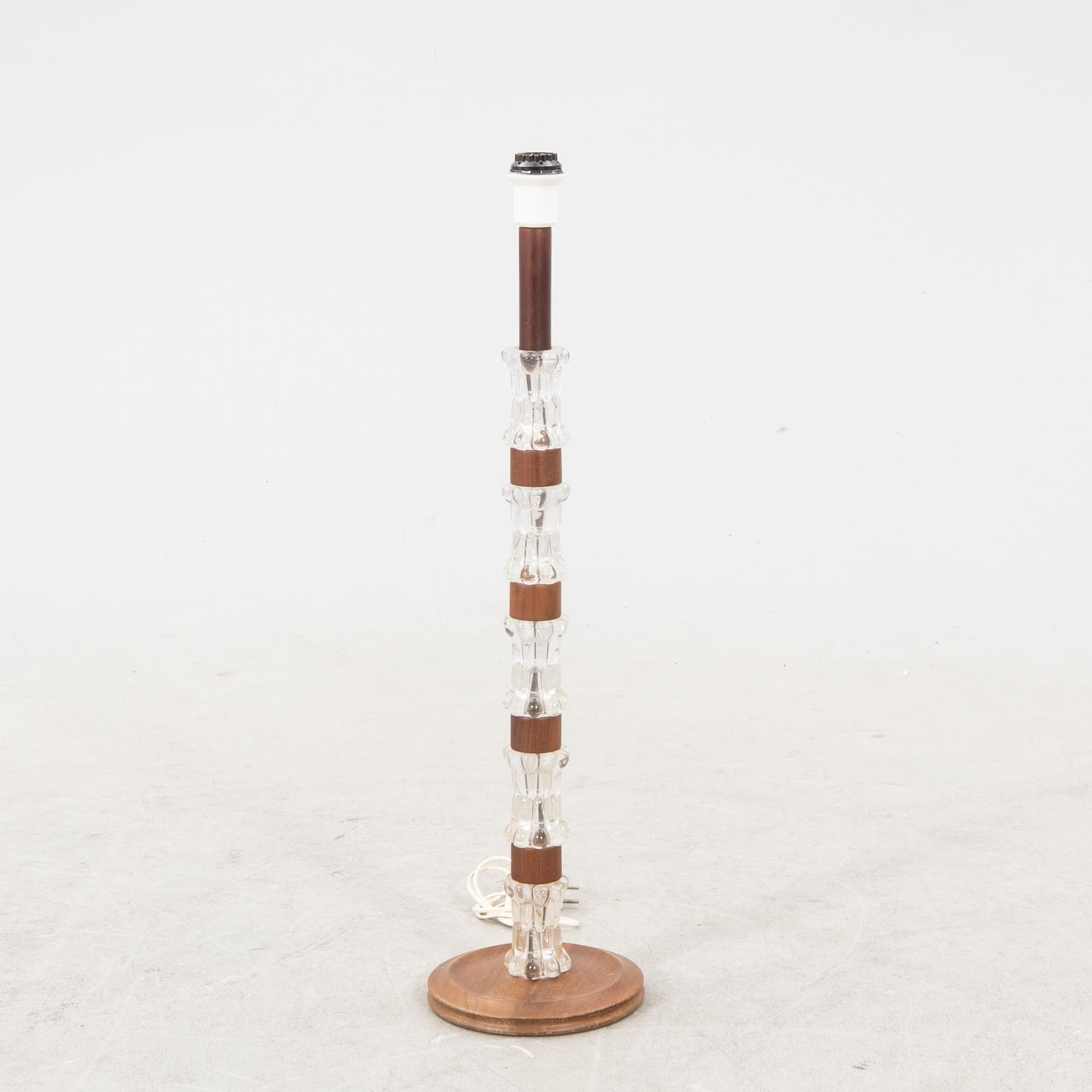 A 1970s wood and glass floor lamp.