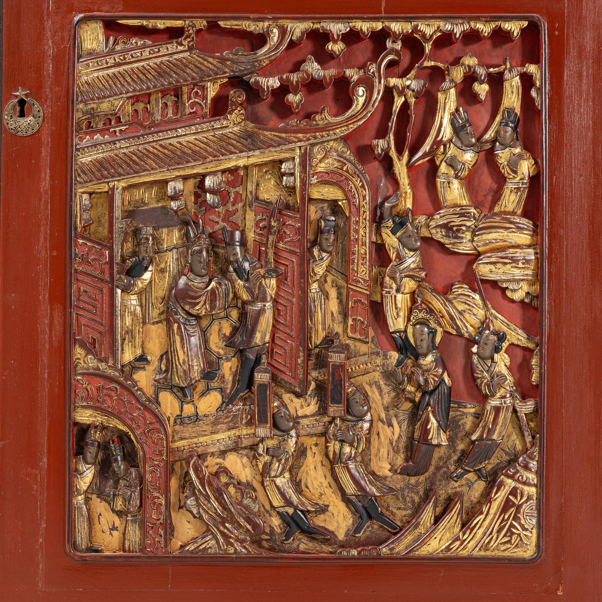 A Chinese cabinet, early 20th Century, with 19th Century carved panels.