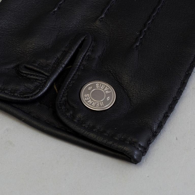 A pair of black lambskin gloves by Hermès.