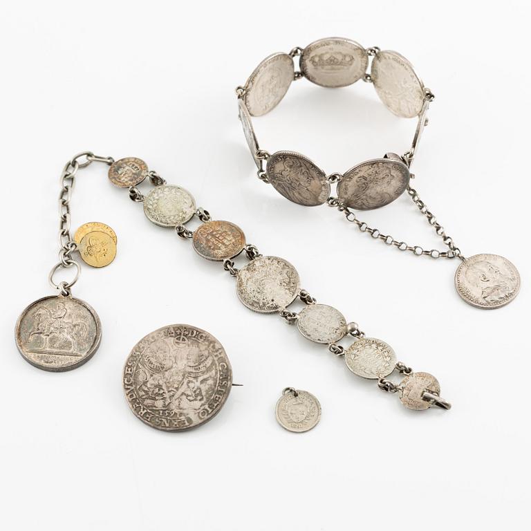 Two bracelets, a brooch, and a pendant with coins.