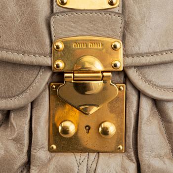 Miu Miu, a light leather handbag.