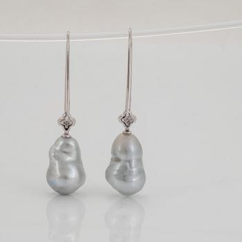 A pair of cultured South Sea pearl earrings in 18K white gold set with round brilliant-cut diamonds.