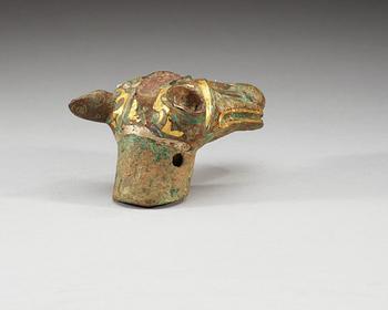 An archaistic bronze handle for a cane in the shape of a mythological animal.