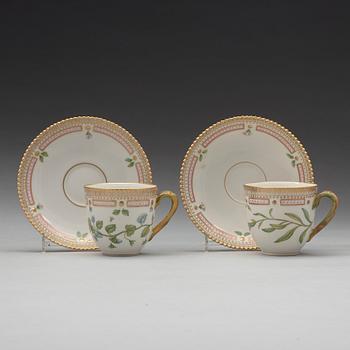 A set of eight cups with stands and six dessert dishes, Royal Copenhagen, 'Flora Danica', 20th Century.