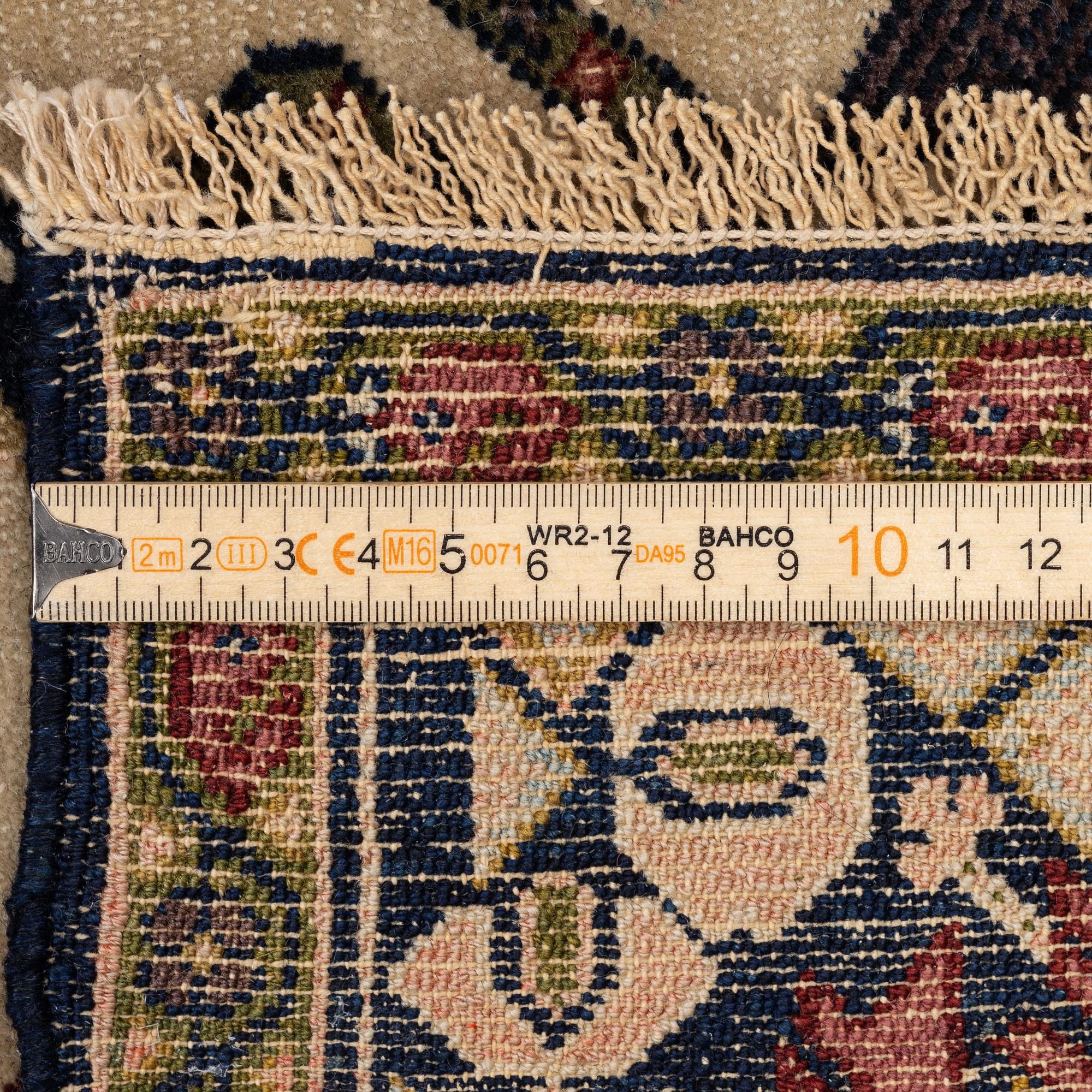 An antique Malajir rug, c. 179,5 x 124 cm (as well as one end with 2.5 cm flat weave).