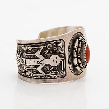 A silver bracelet with coral.