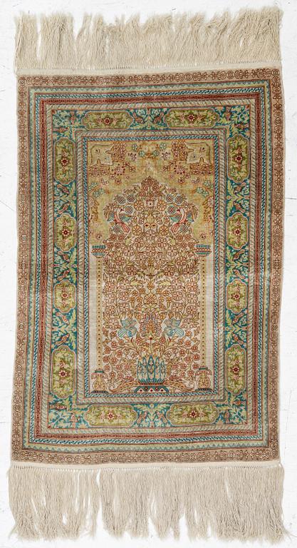 A semi-antique silk Hereke, c. 92 x 61 cm.