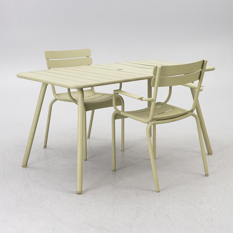 Frédéric Sofia, a table and two chairs for outdoor use, "Luxembourg" Fermob, France, 21st century.