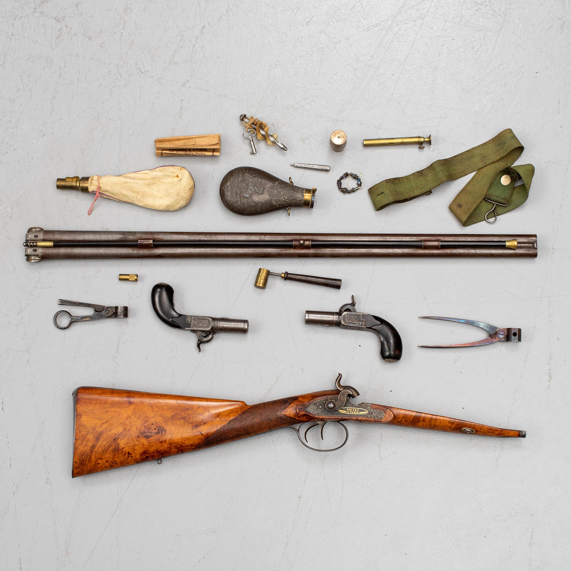 A cased double barreled percussion shotgun marked Gosset a Paris and a pair of percussion pistols marked Fni PAR LEPAGE.