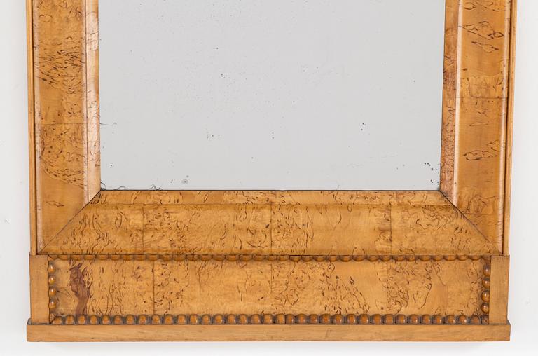 A birch veneered Swedish mirror, late empire, mid 19th Century.