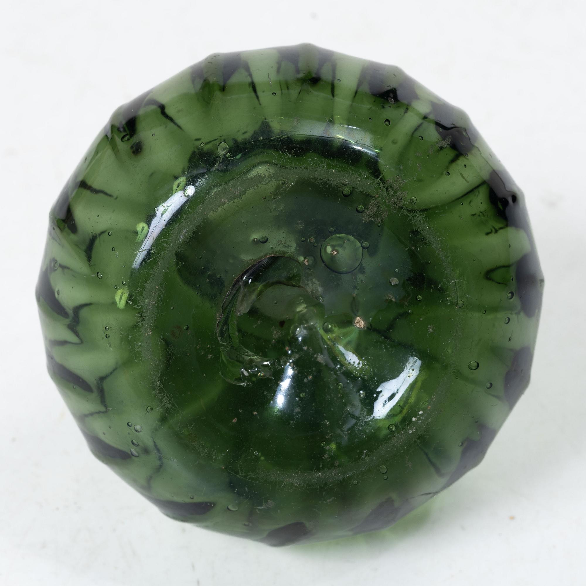 A green twisted glass bottle, 18th century.
