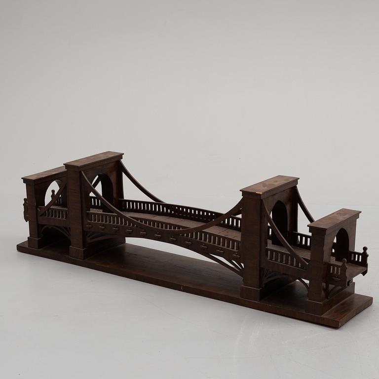 An early 20th century wood model of a bridge.