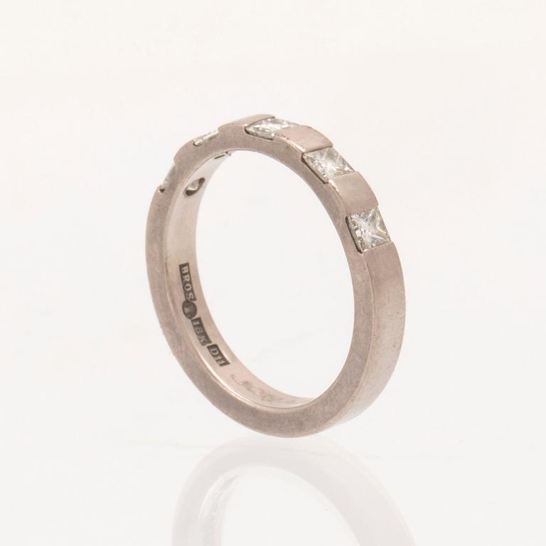 An 18K white gold half-eternity ring set with princess-cut diamonds, Atelje Guld-Bros Stockholm.