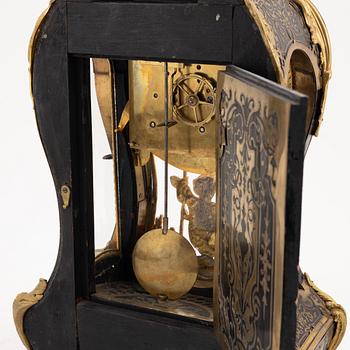 A 19th century rococo style clock, and a 18th century rococo console.