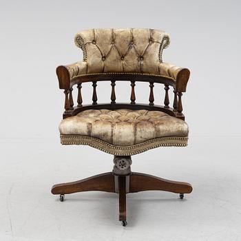 A 20th Century English mahogany and leather desk chair by Hillcrest Chair Actions.