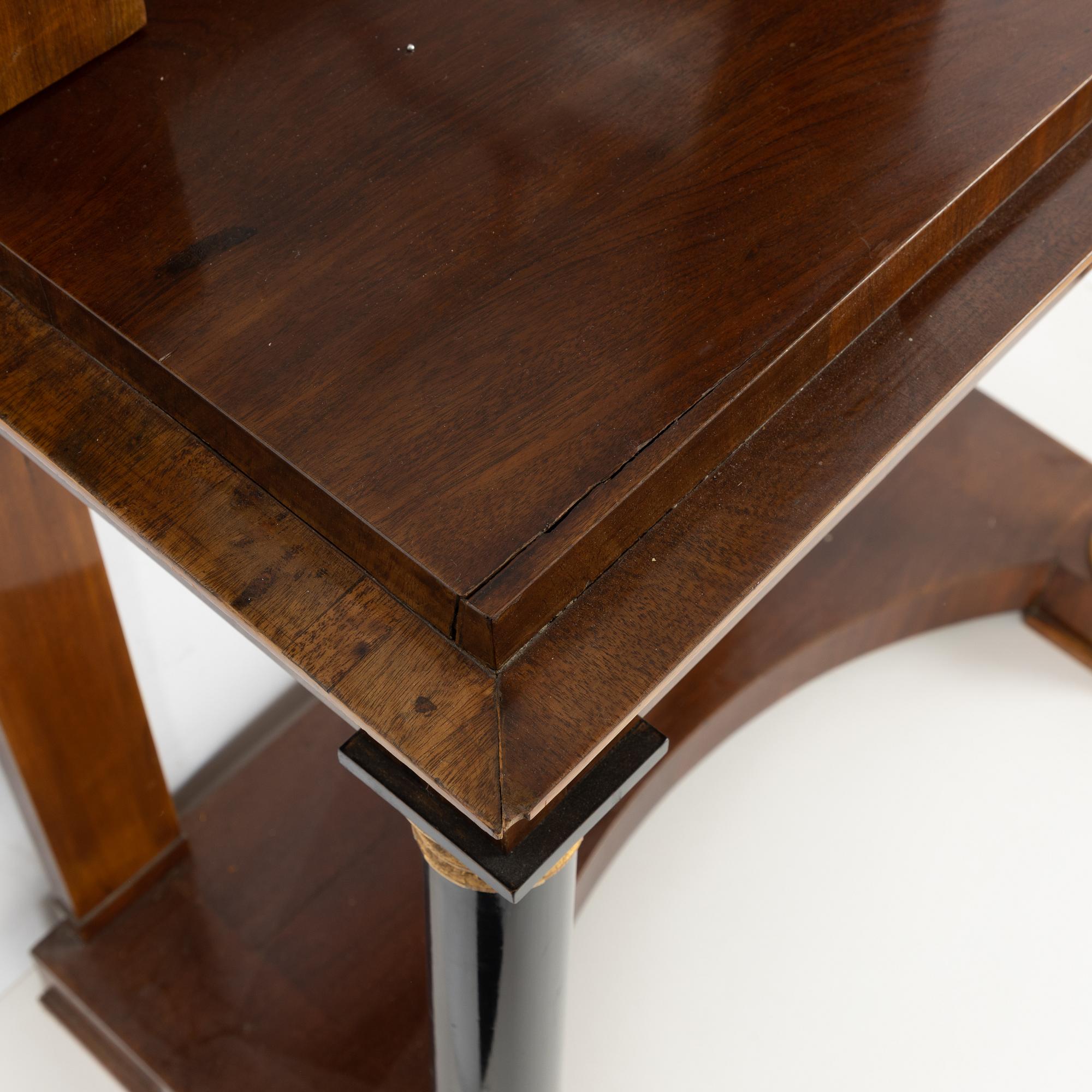 An Empire Mahogany Veneer Mirror and Console Table, first half of the 19th Century.