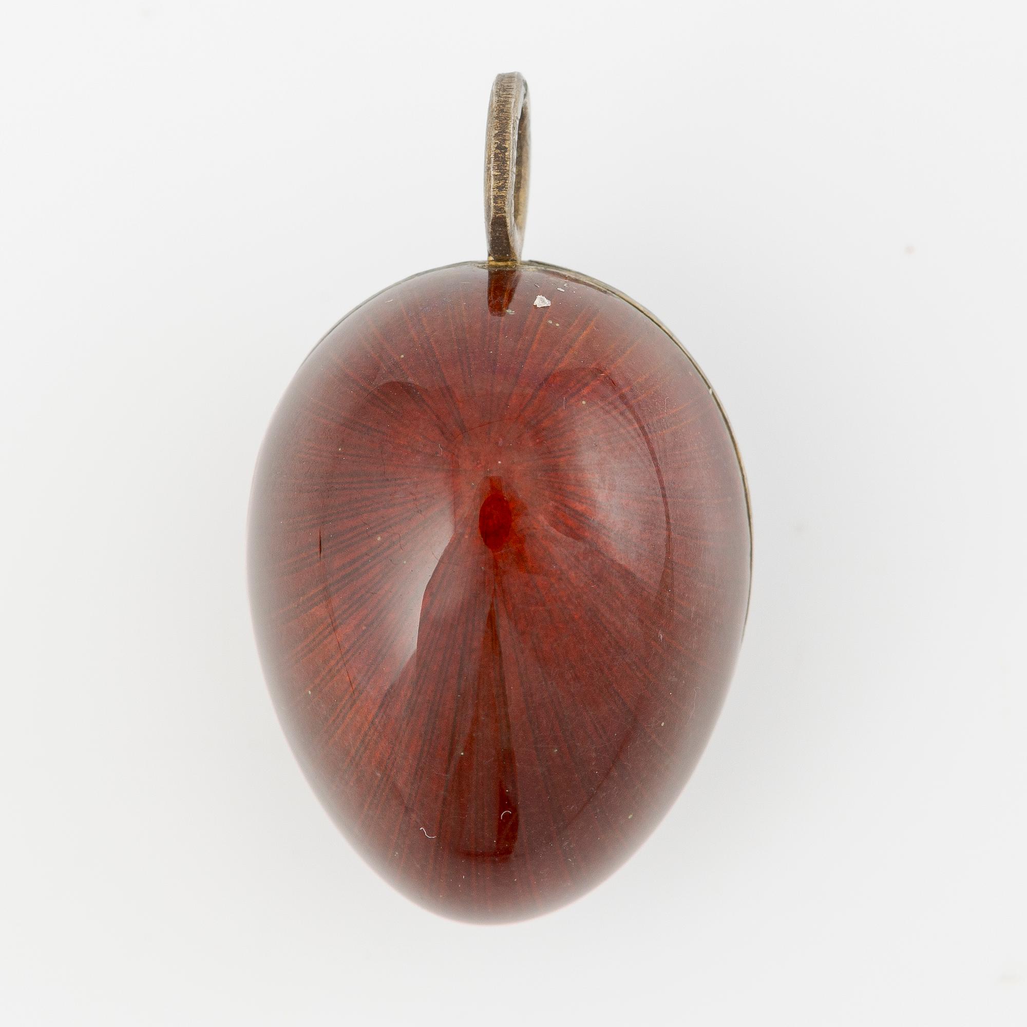Pendant in the shape of an egg, silver with red enamel.