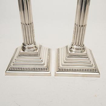 A pair of classical column sterling silver candlesticks Birmingham, 1934, by 'B.G. & Co'.