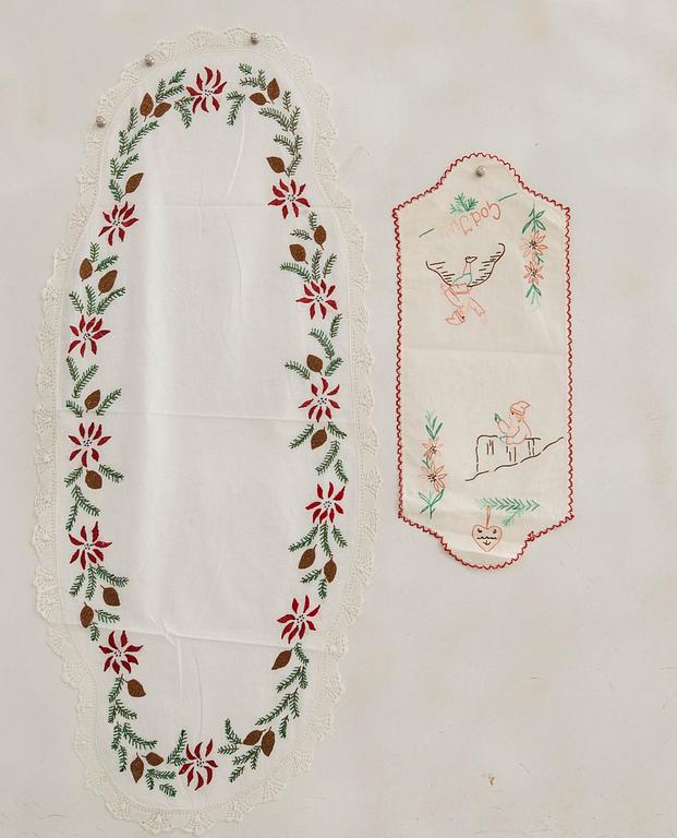 A collection of smaller Christmas tablecloths, runners, and wall hangings, approximately 34 pieces, mid/second half of the 20th century.