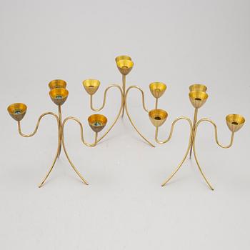Gunnar Ander, a set of three brass five-light candelabra from Ystad Metall.