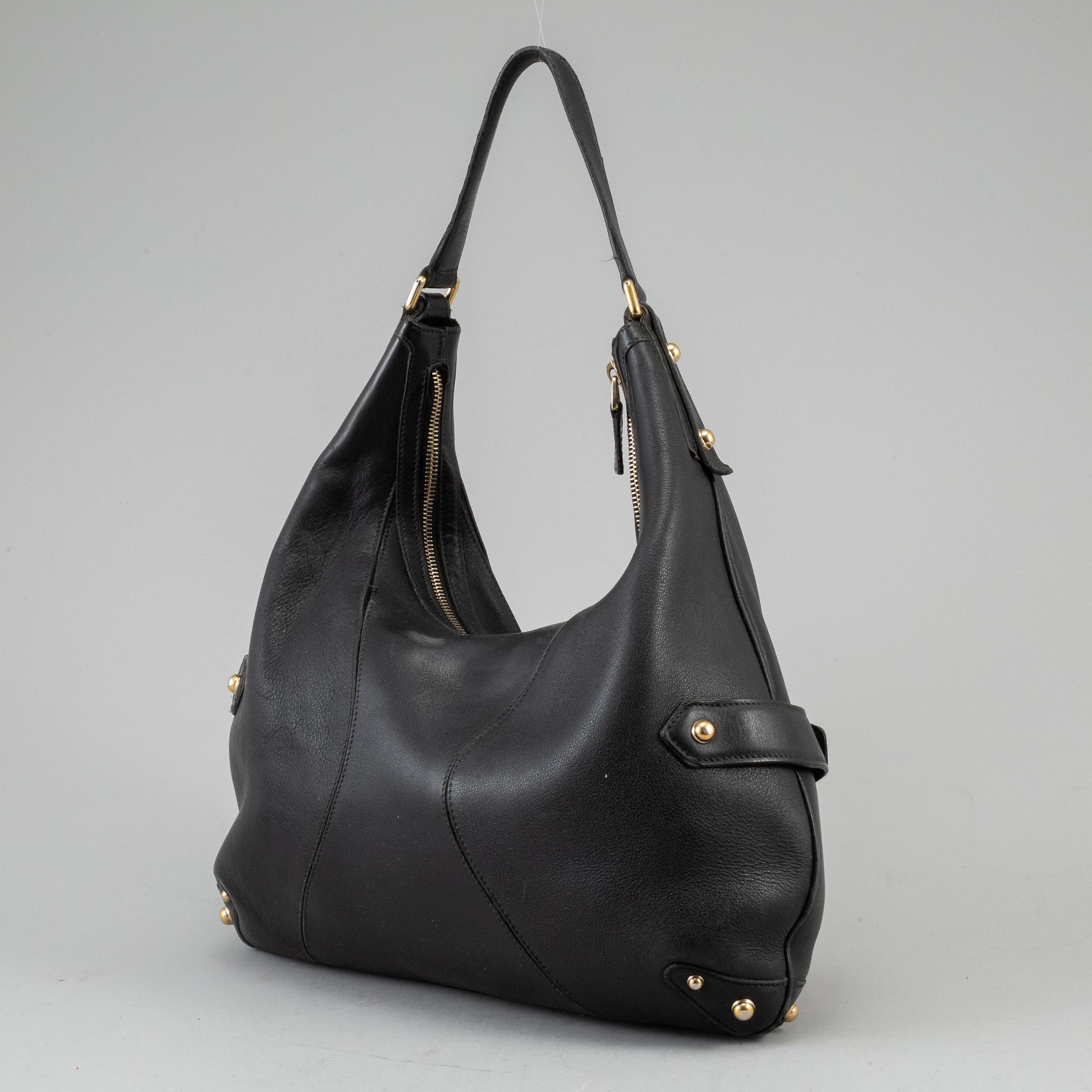 GUCCI, a leather horse-bit bag.